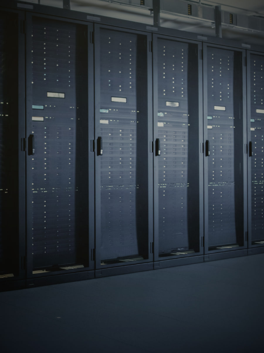 A dark data-center corridor with glowing racks: privacy engineered in every protocol layer