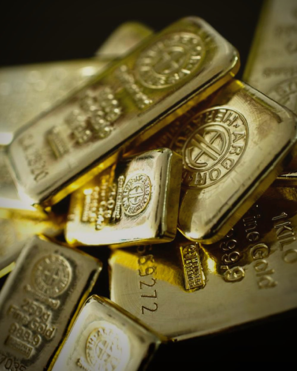 Gold bullion stacked in the darkness of a private vault: wealth held in confidentiality